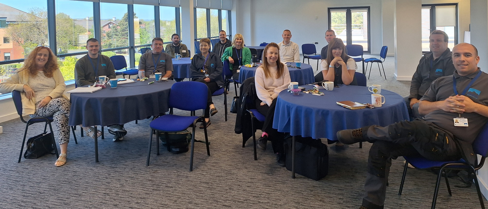 A large diverse group of professionals collaborating around a meeting table